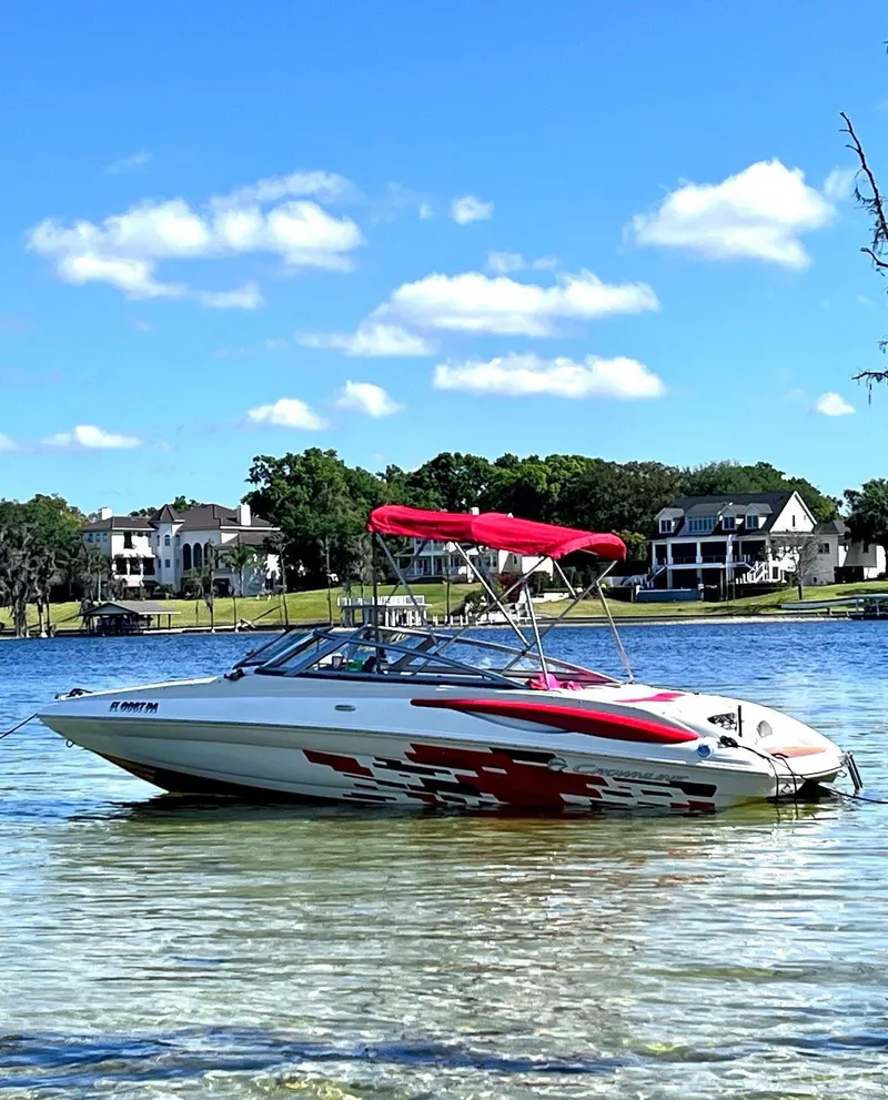 Slide: The Image of 2010 Crownline 195SS boat with red canopy on a sunny lake. - 11