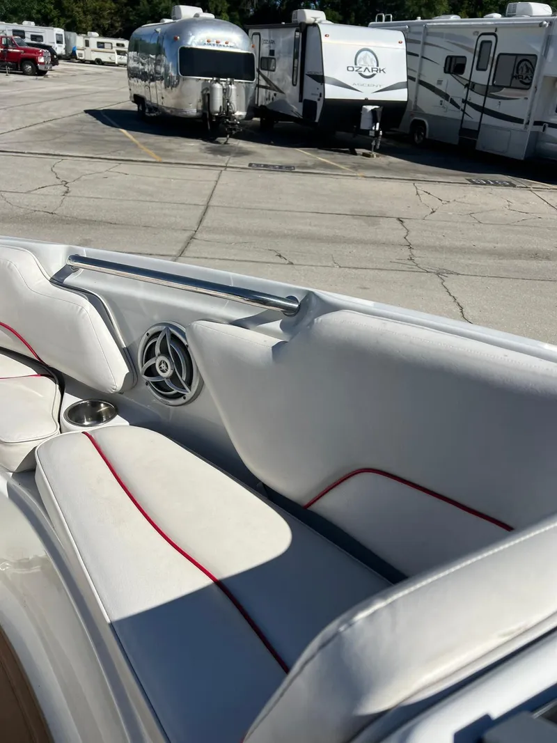 Slide: The Image of 2010 Crownline 195SS boat interior with white seats, red trim, and speaker. - 16