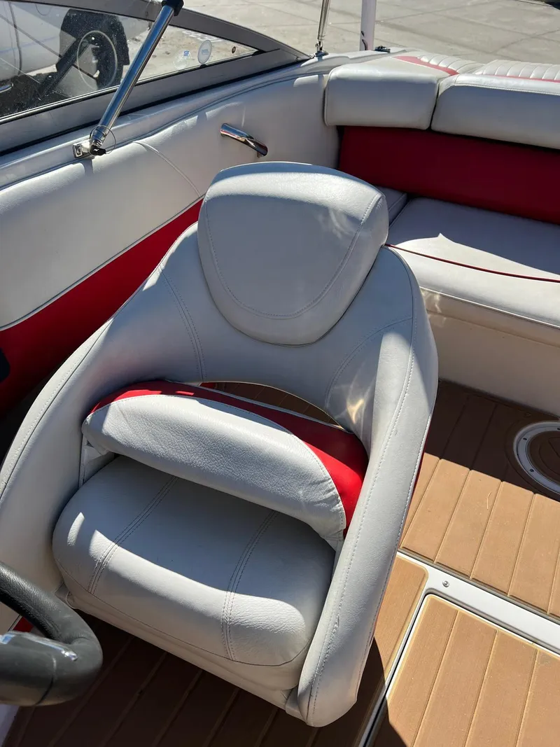 Slide: The Image of 2010 Crownline 195SS boat interior with white and red seating, wooden flooring. - 19