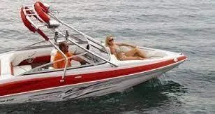 Slide: The Image of 2010 Crownline 195SS boat cruising with passengers on a sunny day. - 2