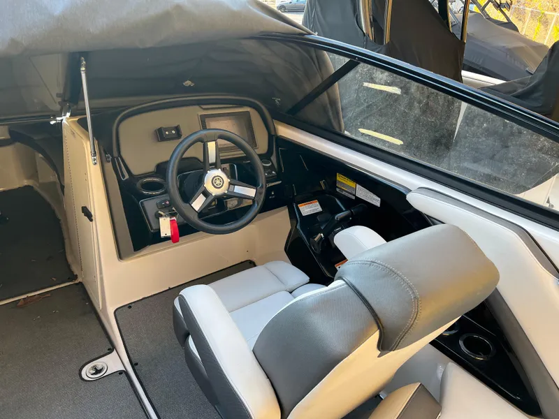 Slide: The Image of 2020 Yamaha AR240 boat interior with steering wheel and seating. - 4