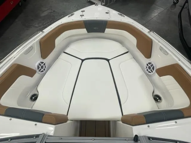 Slide: The Image of 2024 Chaparral 23 SSi boat interior with cushioned seating and speakers. - 2