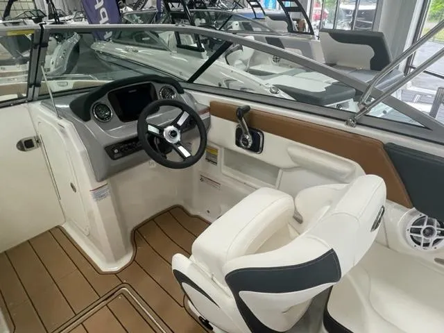 Slide: The Image of 2024 Chaparral 23 SSi boat interior with steering wheel and seating. - 6
