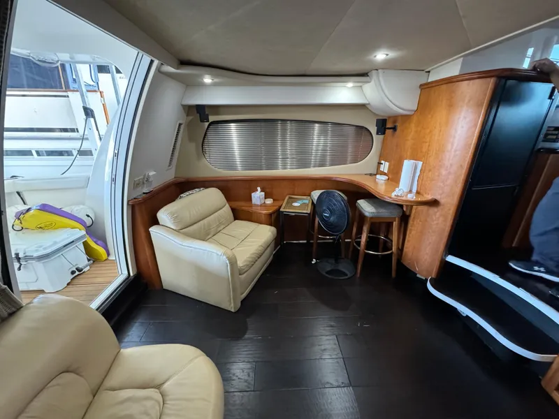 Slide: The Image of Interior of 2001 Silverton 410 Sport Bridge yacht with leather seating and wooden accents. - 10