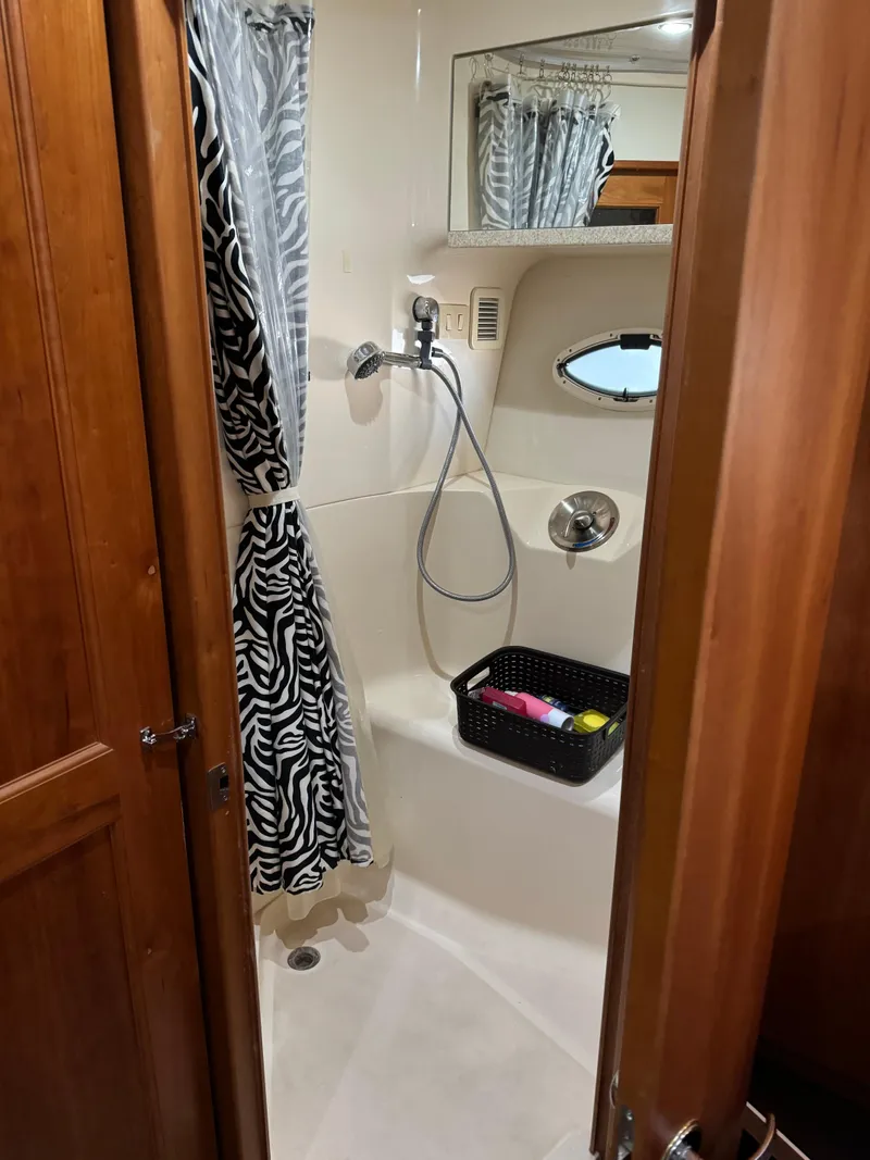 Slide: The Image of Shower area in 2001 Silverton 410 Sport Bridge with zebra-patterned curtain and storage basket. - 15