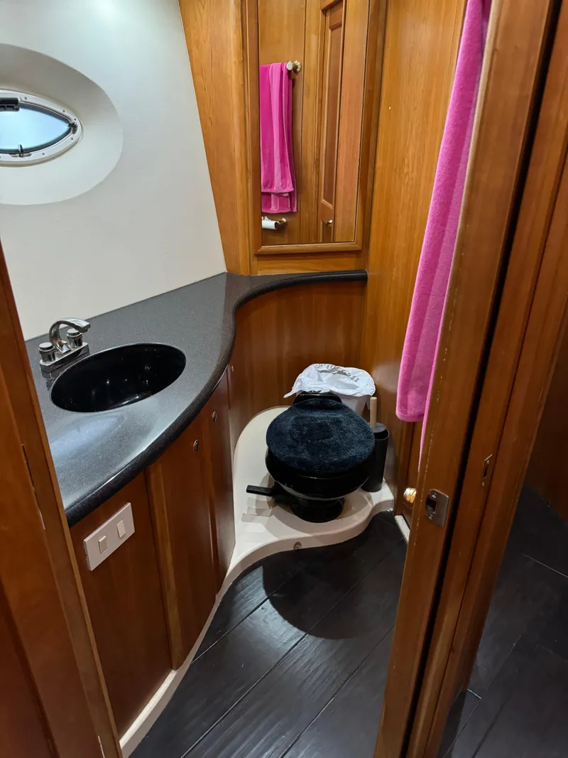 Slide: The Image of 2001 Silverton 410 Sport Bridge bathroom with wood cabinetry and modern fixtures. - 16