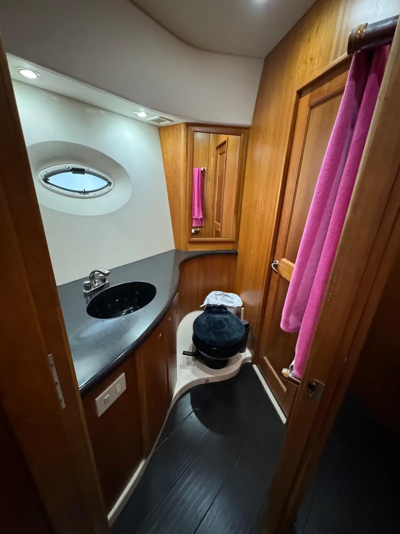 Slide: The Image of 2001 Silverton 410 Sport Bridge bathroom with wood accents and modern fixtures. - 17