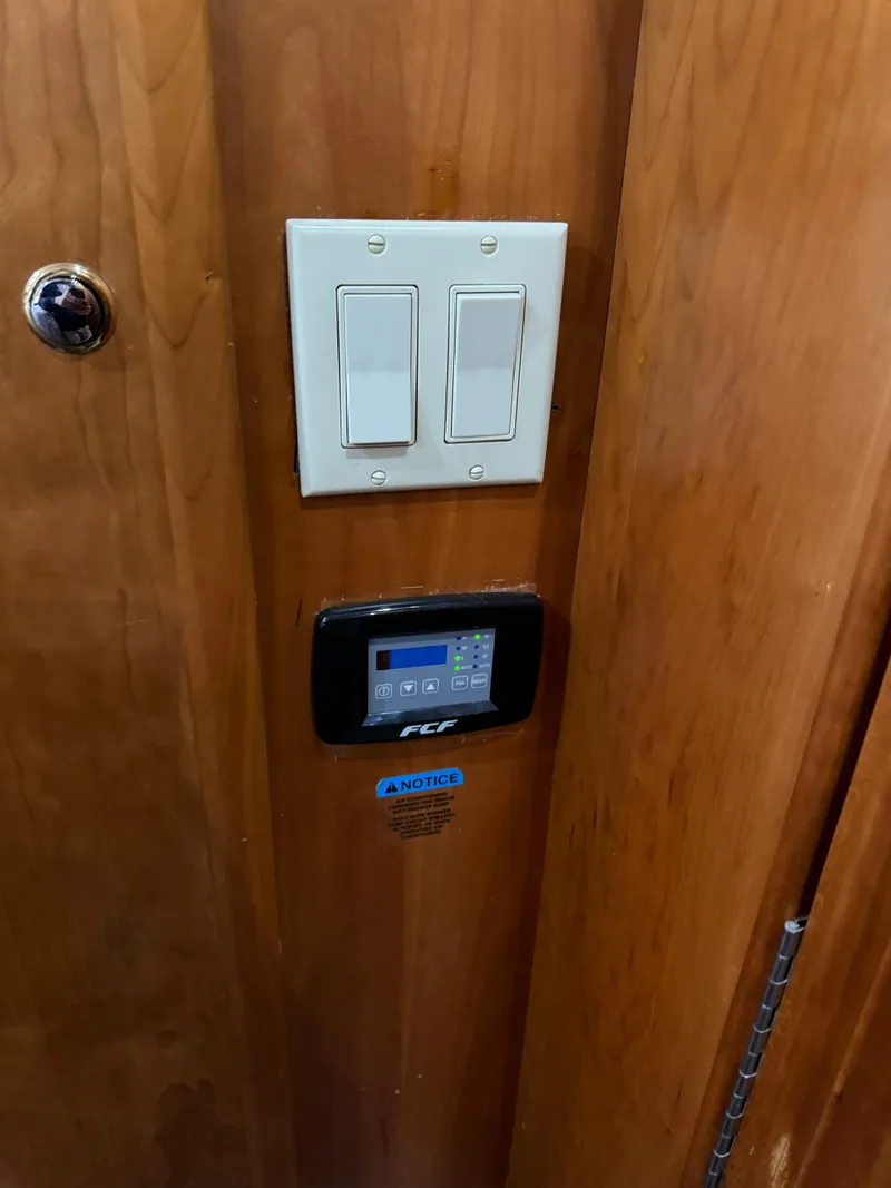 Slide: The Image of Light switches and control panel on 2001 Silverton 410 Sport Bridge yacht interior. - 18