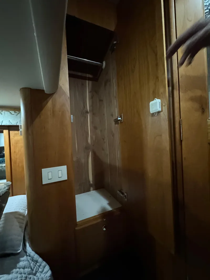 Slide: The Image of Interior of 2001 Silverton 410 Sport Bridge with wooden cabinetry and closet space. - 22