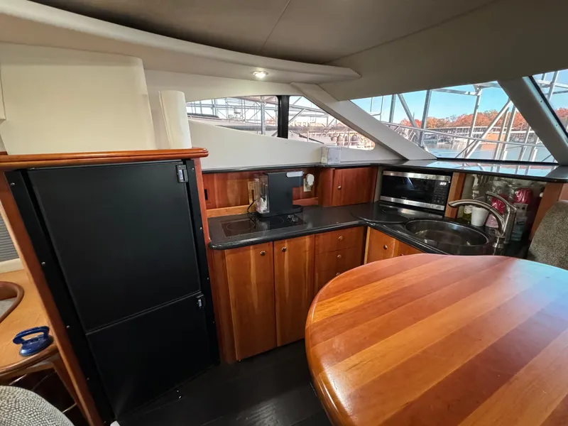 Slide: The Image of Interior of 2001 Silverton 410 Sport Bridge yacht with kitchen and dining area. - 26