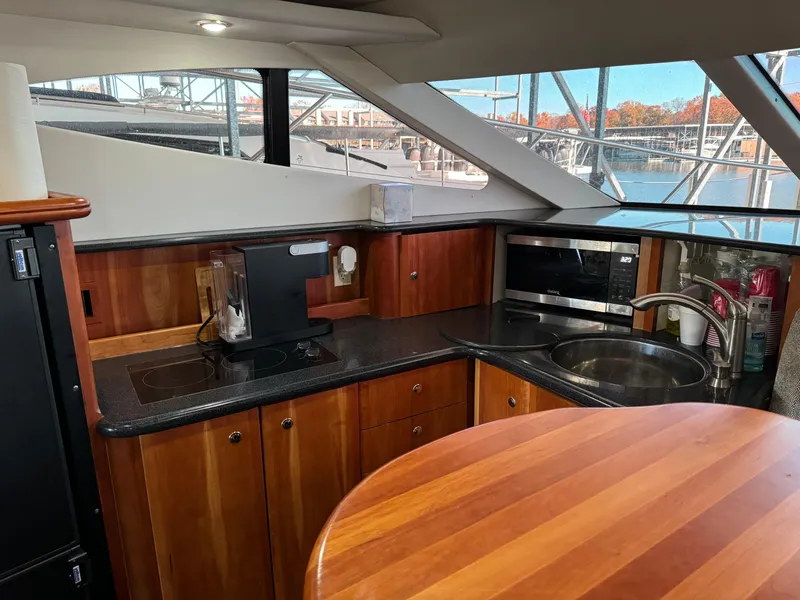 Slide: The Image of 2001 Silverton 410 Sport Bridge kitchen with wood cabinetry and modern appliances. - 27