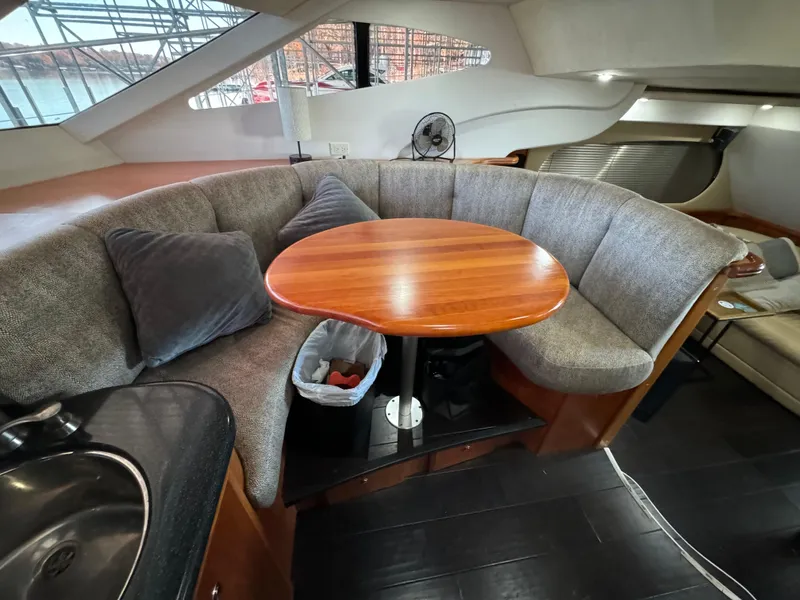 Slide: The Image of Interior of 2001 Silverton 410 Sport Bridge with cozy seating and wooden table. - 28