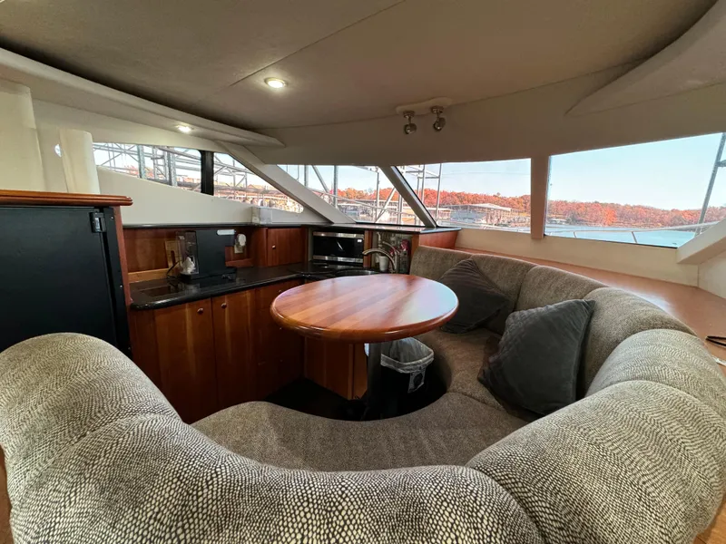 Slide: The Image of Interior of 2001 Silverton 410 Sport Bridge yacht with cozy seating and panoramic windows. - 29