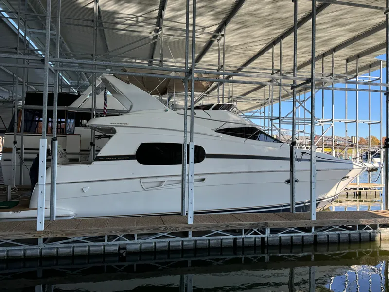 Slide: The Image of 2001 Silverton 410 Sport Bridge yacht docked under a covered marina. - 3
