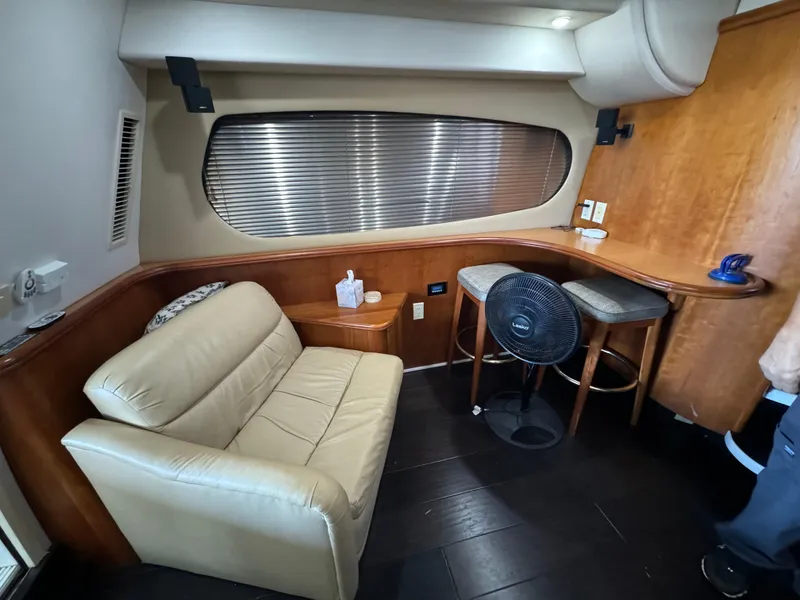 Slide: The Image of Interior of 2001 Silverton 410 Sport Bridge with beige sofa and wooden accents. - 30