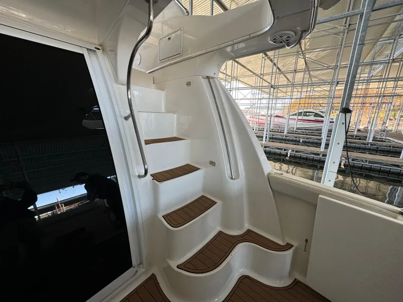 Slide: The Image of Staircase on 2001 Silverton 410 Sport Bridge yacht in marina setting. - 31