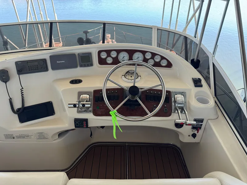 Slide: The Image of 2001 Silverton 410 Sport Bridge helm with steering wheel and control panel. - 33
