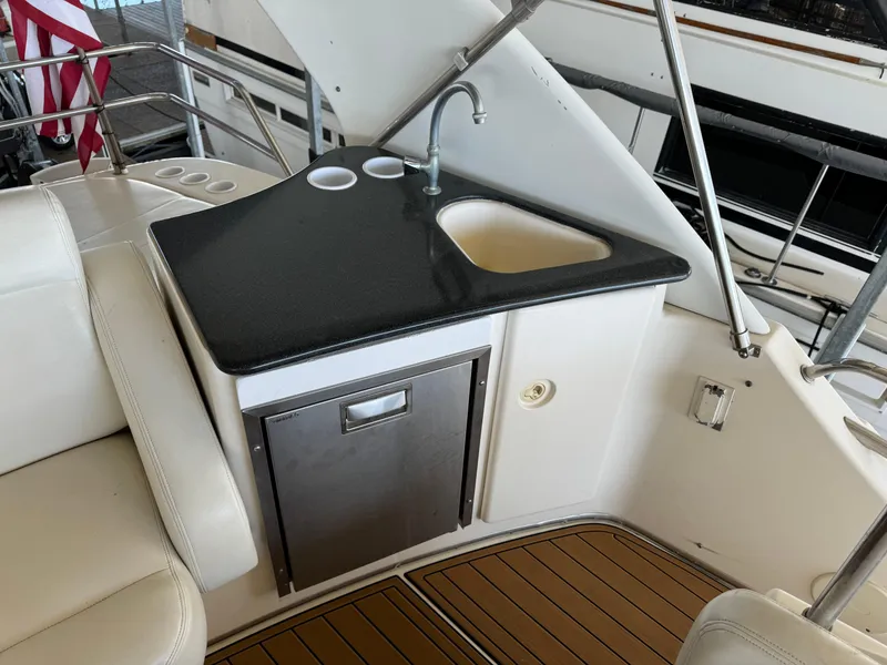Slide: The Image of 2001 Silverton 410 Sport Bridge yacht kitchenette with sink and mini fridge. - 34
