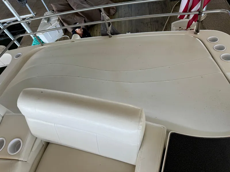 Slide: The Image of 2001 Silverton 410 Sport Bridge boat deck with white seating and cup holders. - 35