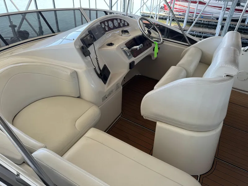 Slide: The Image of 2001 Silverton 410 Sport Bridge helm with white seating and wood flooring. - 37