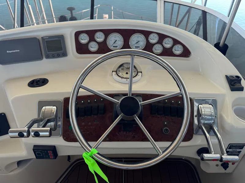 Slide: The Image of 2001 Silverton 410 Sport Bridge helm with steering wheel and control panel. - 38