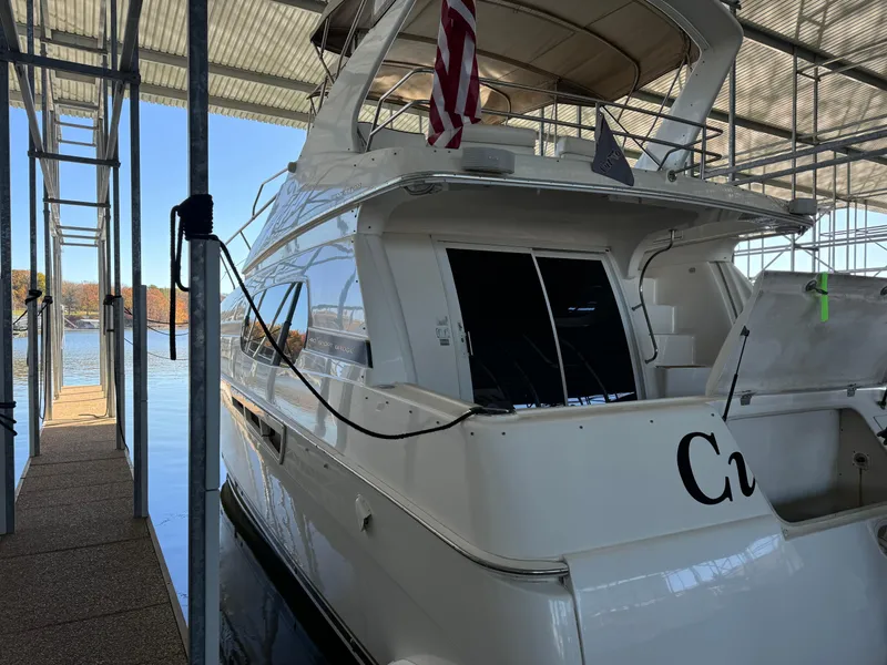 Slide: The Image of 2001 Silverton 410 Sport Bridge yacht docked in a marina. - 4