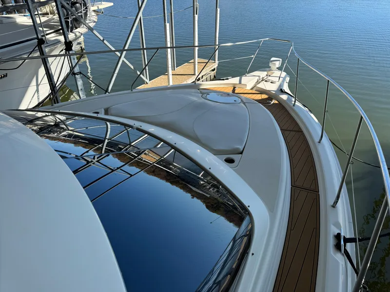 Slide: The Image of 2001 Silverton 410 Sport Bridge yacht with sleek deck design and water reflection. - 43