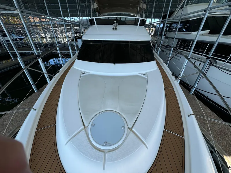 Slide: The Image of 2001 Silverton 410 Sport Bridge yacht docked in a marina, showcasing sleek design and spacious deck. - 44