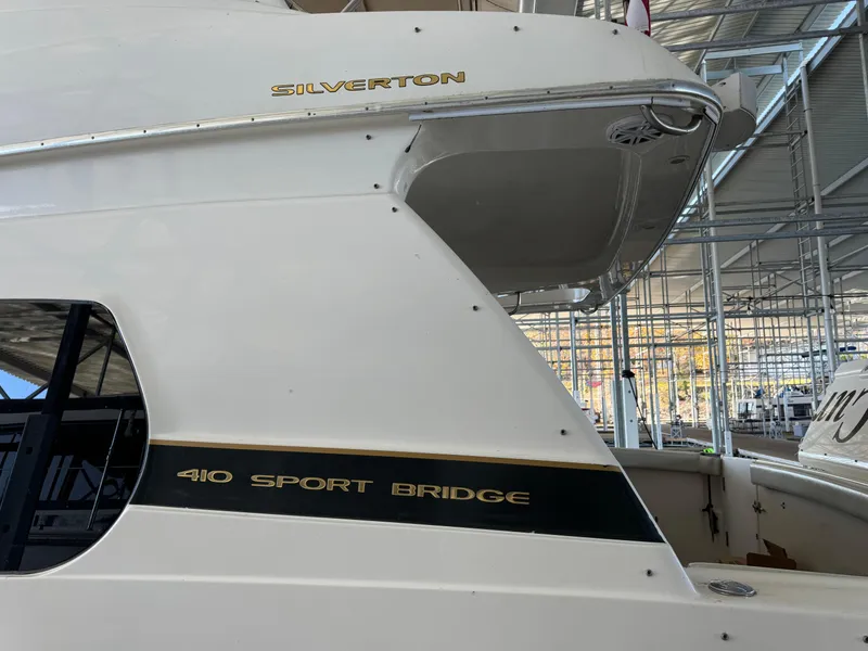 Slide: The Image of 2001 Silverton 410 Sport Bridge yacht in marina, side view. - 5