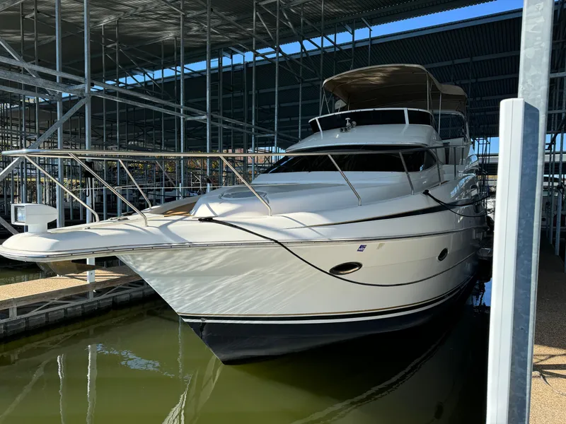 Slide: The Image of 2001 Silverton 410 Sport Bridge yacht docked in a covered marina. - 6