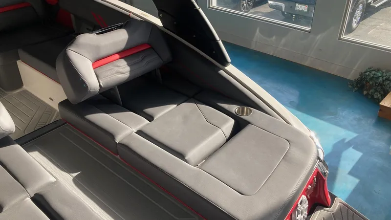 Slide: The Image of 2025 Regal LS4 boat interior with gray and red seating, cup holder, and modern design. - 3