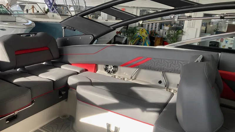Slide: The Image of Interior of 2025 Regal LS4 boat with sleek gray and red seating. - 6