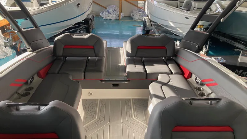 Slide: The Image of 2025 Regal LS4 boat interior with gray and red seating, spacious layout. - 7