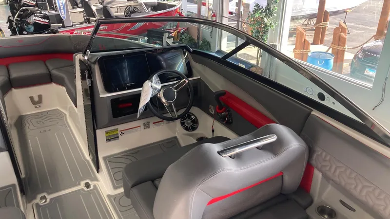 Slide: The Image of 2025 Regal LS4 boat interior with modern dashboard and seating. - 8