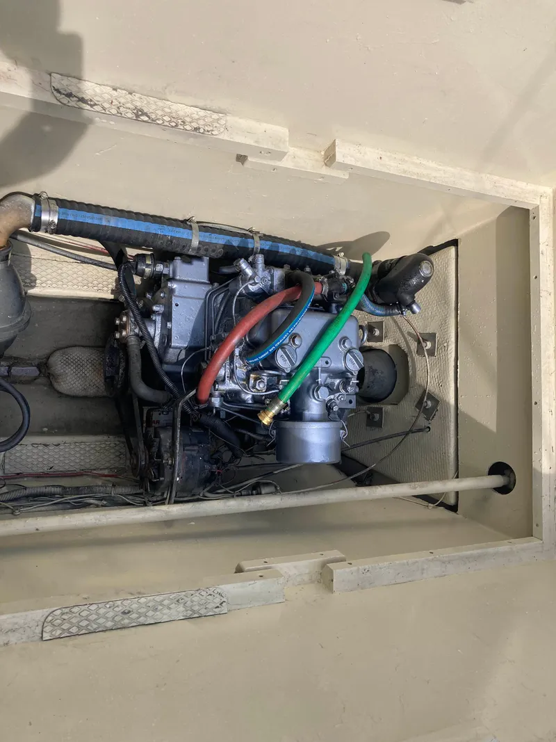 Slide: The Image of Engine compartment of 1979 Catamaran Ocean Winds 33, showing detailed mechanical components. - 14