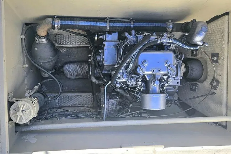 Slide: The Image of Engine compartment of a 1979 Catamaran Ocean Winds 33, showcasing mechanical components. - 16