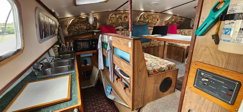 Slide: The Image of Interior of 1979 Catamaran Ocean Winds 33, featuring kitchen and seating area. - 8