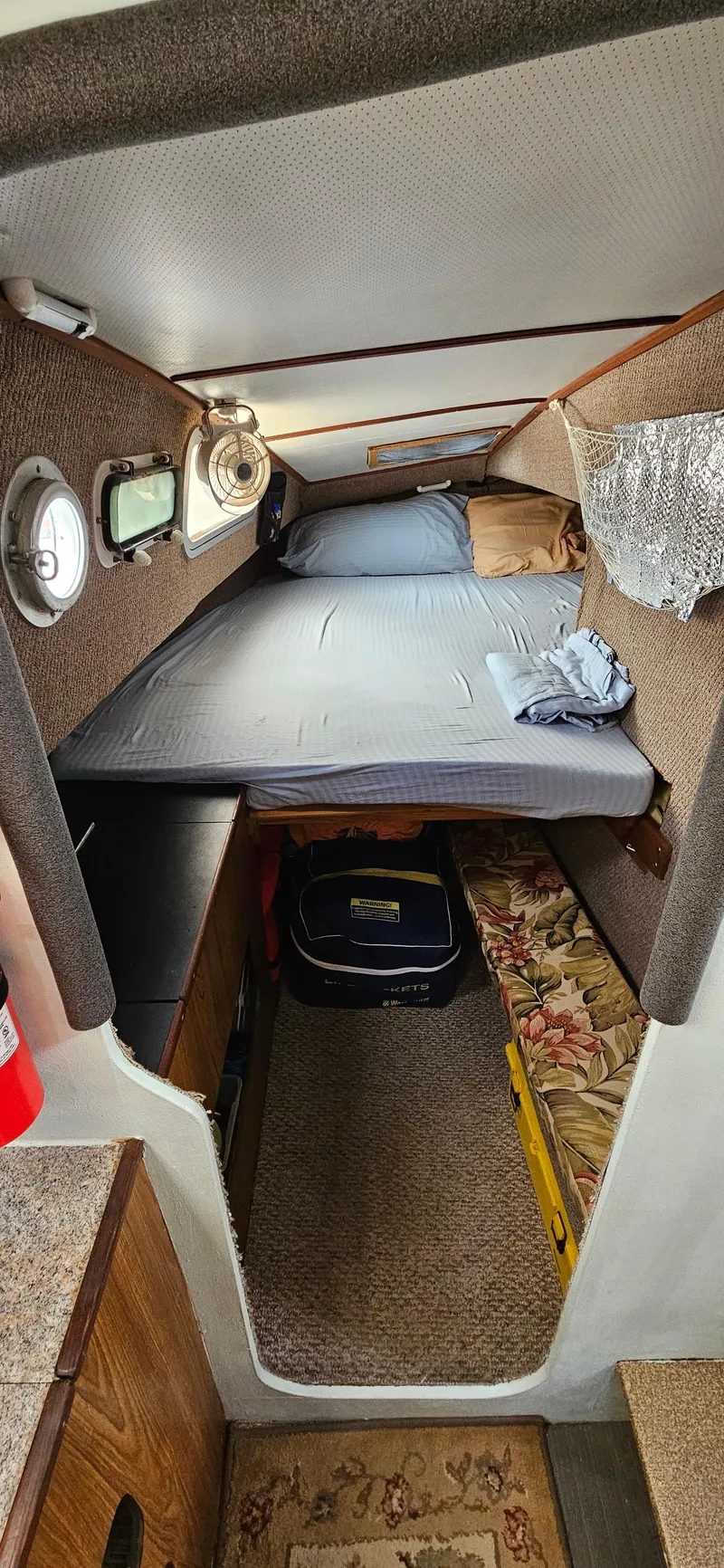 Slide: The Image of Interior cabin of 1979 Catamaran Ocean Winds 33 with bed and storage. - 9