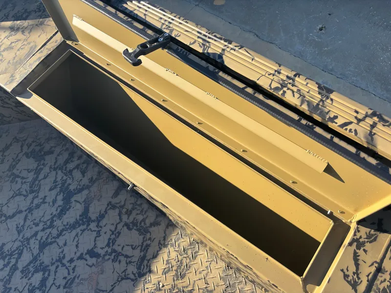Slide: The Image of Open storage compartment in 2025 Edge Duck Boats 556 DB, featuring camouflage design. - 7