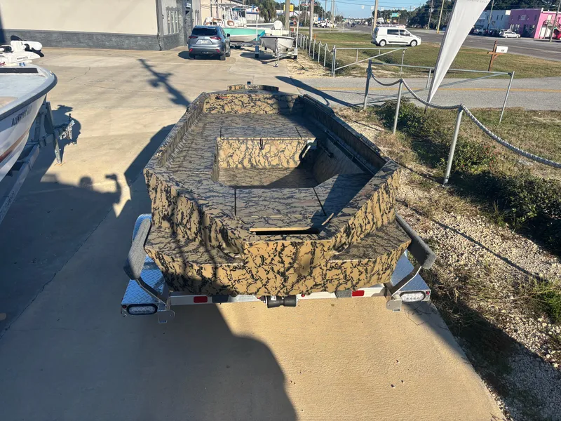 Slide: The Image of 2025 Edge Duck Boats 556 DB with camouflage design on a trailer. - 2