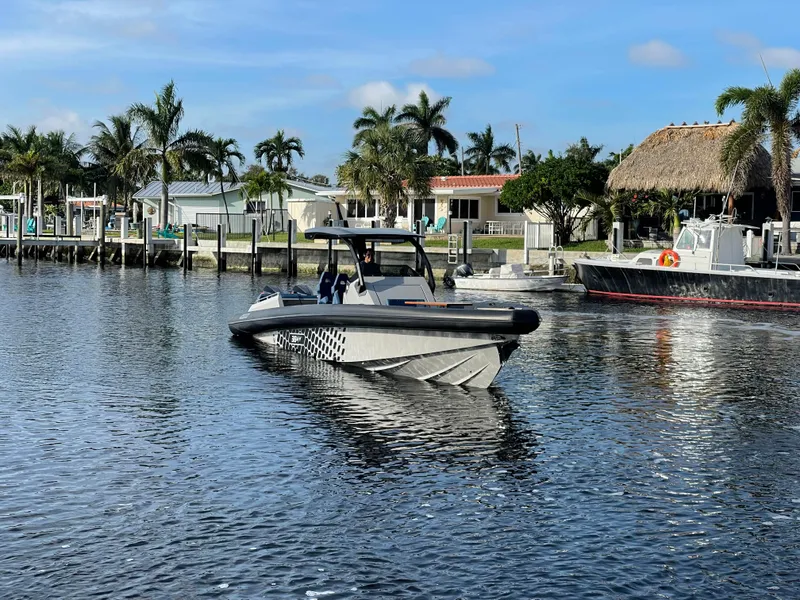 Slide: The Image of 2023 Skipper-BSK 38NC boat on calm water near a tropical marina. - 12