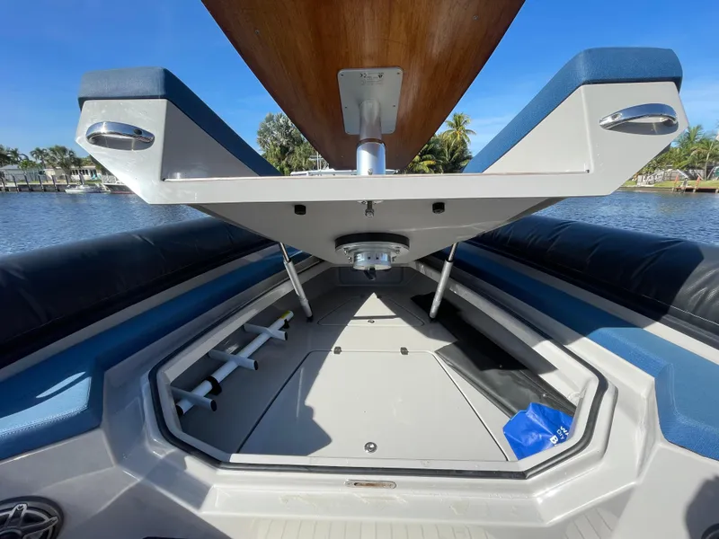 Slide: The Image of 2023 Skipper-BSK 38NC boat interior with open storage compartment, blue and gray seating. - 17