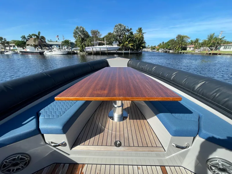 Slide: The Image of Luxury Skipper-BSK 38NC boat interior with wooden table and blue seating, 2023 model. - 18