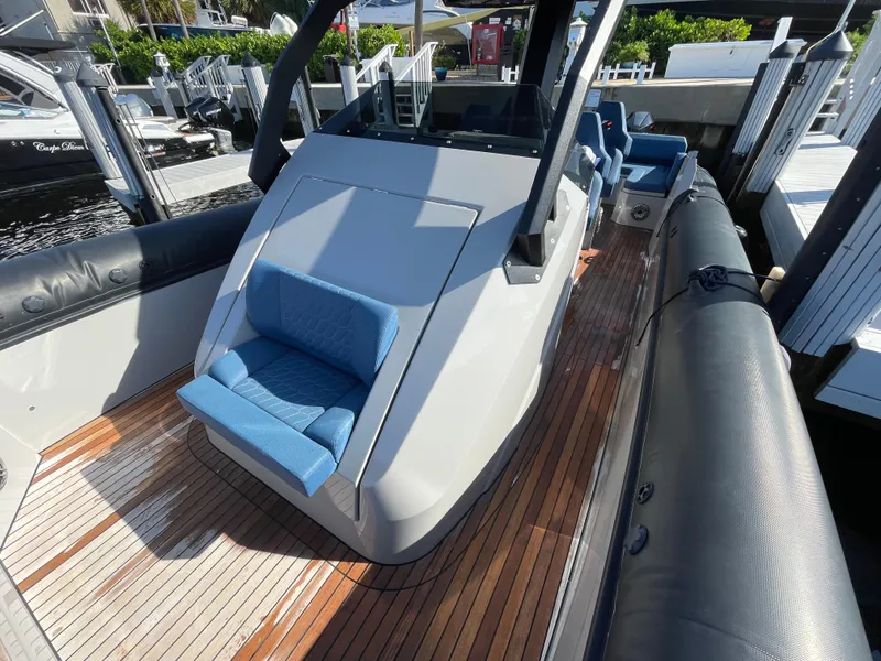 Slide: The Image of 2023 Skipper-BSK 38NC boat with sleek design and blue seating on wooden deck. - 22