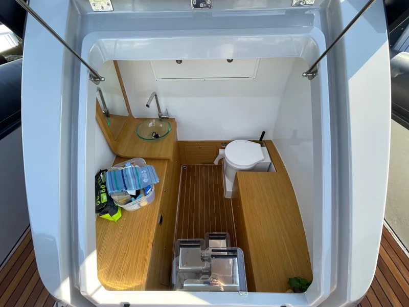 Slide: The Image of 2023 Skipper-BSK 38NC boat interior with wooden flooring and compact bathroom amenities. - 26