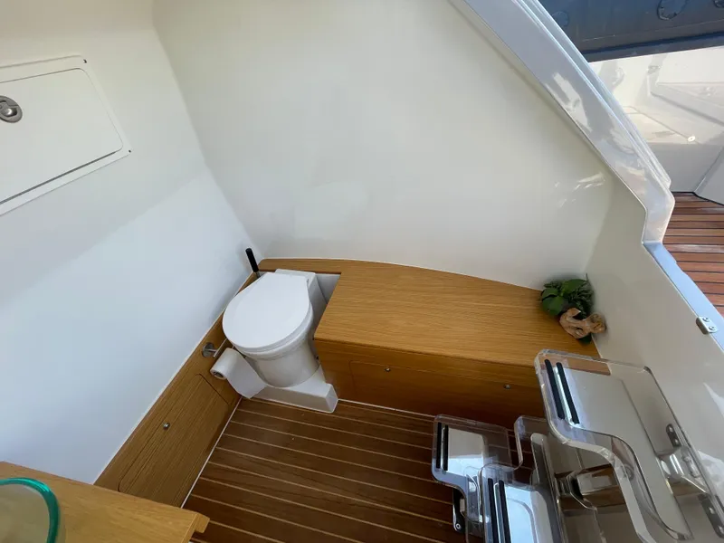Slide: The Image of 2023 Skipper-BSK 38NC boat interior with wooden flooring and compact toilet. - 28