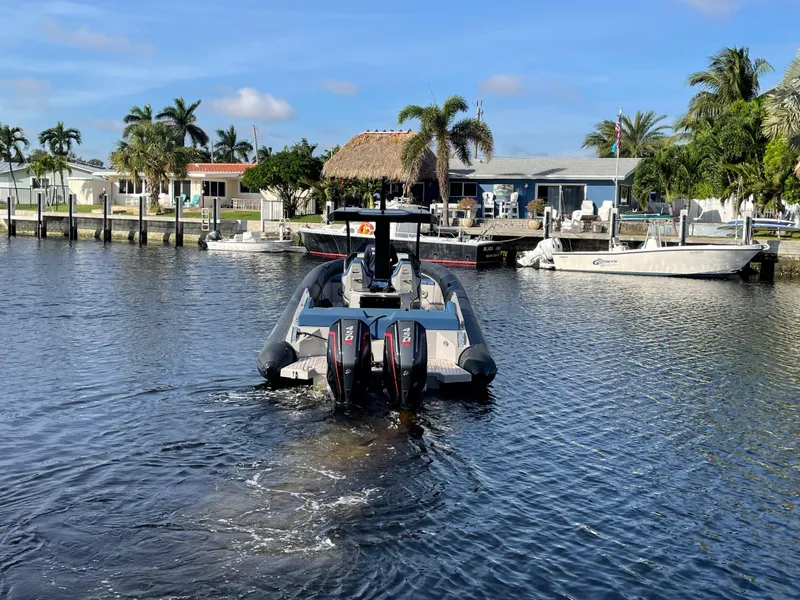 Slide: The Image of 2023 Skipper-BSK 38NC boat with dual engines on a sunny waterfront. - 3