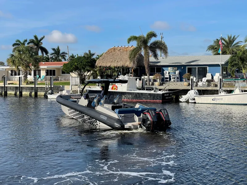 Slide: The Image of Skipper-BSK 38NC boat cruising near waterfront homes, 2023 model. - 4