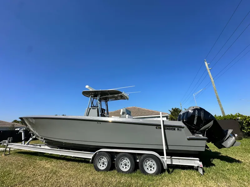 The Image of 2005 Contender 36 Open boat on trailer under clear blue sky. - 0