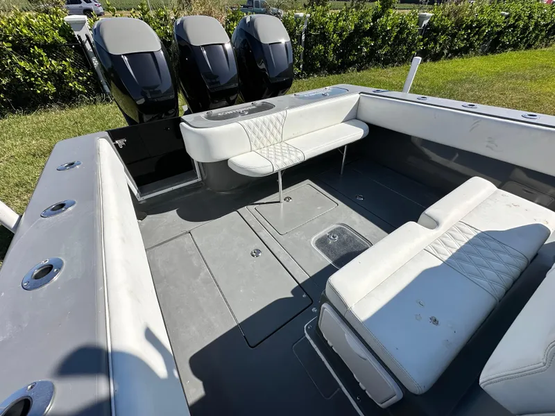 Slide: The Image of 2005 Contender 36 Open boat interior with seating and triple outboard engines. - 10